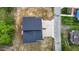 Aerial view of modern duplex featuring a driveway and wooden balconies near a quiet road at 836 Day Ave, Burlington, NC 27217