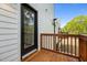 Wooden porch featuring a wooden safety rail and views into the trees at 836 Day Ave, Burlington, NC 27217