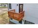 This back porch has a wooden safety rail for enjoying the outdoors at 836 Day Ave, Burlington, NC 27217