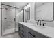 Modern bathroom featuring a glass-enclosed shower and a double vanity with sleek black fixtures and contemporary lighting at 836 Day Ave, Burlington, NC 27217