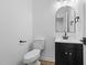 A half bathroom with a modern toilet, vanity, and stylish black fixtures at 836 Day Ave, Burlington, NC 27217