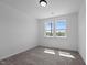 A bright bedroom with gray carpet, two large windows, and an abundance of natural light at 836 Day Ave, Burlington, NC 27217