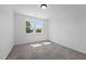 Bright bedroom with gray carpet, two large windows, and an abundance of natural light at 836 Day Ave, Burlington, NC 27217