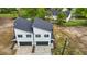 Aerial view of a modern duplex featuring attached garages, gray roof, and manicured landscaping at 836 Day Ave, Burlington, NC 27217