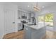 Modern kitchen features gray cabinets, a center island with quartz countertops, and stainless steel appliances at 836 Day Ave, Burlington, NC 27217