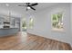 Open-concept living area showcasing hardwood floors, windows, and a modern kitchen with gray cabinets at 836 Day Ave, Burlington, NC 27217