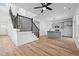 Open-concept living area showcasing hardwood floors, a staircase, and modern kitchen with gray cabinets at 836 Day Ave, Burlington, NC 27217