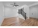 Spacious living room features wood floors, a staircase, a ceiling fan, and plenty of natural light at 836 Day Ave, Burlington, NC 27217