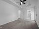This carpeted main bedroom boasts a trey ceiling with fan and ample natural light near the ensuite bathroom and walk-in closet at 836 Day Ave, Burlington, NC 27217