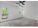 This main bedroom has plush carpet, a trey ceiling with fan, access to a private balcony, and plenty of natural light at 836 Day Ave, Burlington, NC 27217