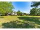 Expansive backyard featuring a well-maintained lawn and a beautiful two-story house at 8409 Muirfield Dr, Fuquay Varina, NC 27526