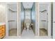Bathroom featuring two closets with wallpaper and a white toilet at 8409 Muirfield Dr, Fuquay Varina, NC 27526