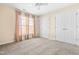 Bedroom with carpet, beige curtains, white walls, and closet doors at 8409 Muirfield Dr, Fuquay Varina, NC 27526