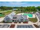 Beautiful clubhouse with a pool, parking, and lake view on a sunny day at 8409 Muirfield Dr, Fuquay Varina, NC 27526
