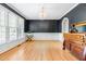 Elegant dining room with dark walls, hardwood floors and plenty of natural light at 8409 Muirfield Dr, Fuquay Varina, NC 27526