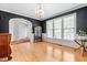 Open dining room featuring hardwood floors, chandelier and view of entryway at 8409 Muirfield Dr, Fuquay Varina, NC 27526