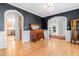 Open dining room with hardwood floors and view into the kitchen and living room at 8409 Muirfield Dr, Fuquay Varina, NC 27526