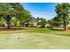 Scenic view of a meticulously maintained golf course with the residence in the background at 8409 Muirfield Dr, Fuquay Varina, NC 27526