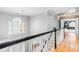 Upstairs hallway features hardwood floors and a window with a view at 8409 Muirfield Dr, Fuquay Varina, NC 27526