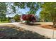 A brick home with a long driveway and a detached garage at 8409 Muirfield Dr, Fuquay Varina, NC 27526