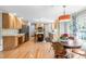 Open eat-in kitchen and dining area featuring hardwood floors and ample natural light at 8409 Muirfield Dr, Fuquay Varina, NC 27526