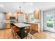 Kitchen features light wood cabinetry, stainless appliances, and an eat-in island at 8409 Muirfield Dr, Fuquay Varina, NC 27526