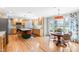 Bright kitchen with light wood cabinets, island with seating, and breakfast nook at 8409 Muirfield Dr, Fuquay Varina, NC 27526