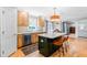 Eat-in kitchen features a center island with barstool seating and hardwood flooring at 8409 Muirfield Dr, Fuquay Varina, NC 27526