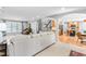 Spacious living room with large white sofa that opens to the kitchen and entryway at 8409 Muirfield Dr, Fuquay Varina, NC 27526