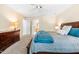 Main bedroom with hardwood furniture, neutral colors, and an ensuite bathroom at 8409 Muirfield Dr, Fuquay Varina, NC 27526