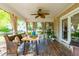 Sunroom with a dining table, wooden bench, potted plants and neutral paint colors at 8409 Muirfield Dr, Fuquay Varina, NC 27526
