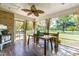 Sunroom with a wooden dining table and neutral colors with a ceiling fan at 8409 Muirfield Dr, Fuquay Varina, NC 27526