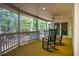 Inviting back porch with wood floors, ceiling fan and wooded view, perfect for relaxation at 910 Old Orchard Rd, Chapel Hill, NC 27517