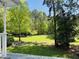 A peaceful backyard with mature trees, lush lawn, and a cozy seating area, ideal for relaxation and entertaining at 910 Old Orchard Rd, Chapel Hill, NC 27517