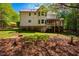 Expansive backyard featuring a deck, stairs, and mature trees providing ample shade at 910 Old Orchard Rd, Chapel Hill, NC 27517