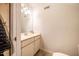 Simple half bathroom with single vanity, mirror and white walls at 910 Old Orchard Rd, Chapel Hill, NC 27517
