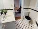 A bathroom featuring marble countertops and classic black and white tile flooring at 910 Old Orchard Rd, Chapel Hill, NC 27517