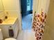 Bright bathroom with a sink and vanity, next to the combination shower and tub at 910 Old Orchard Rd, Chapel Hill, NC 27517