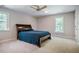 Spacious bedroom with neutral carpet and walls, and two windows for natural light at 910 Old Orchard Rd, Chapel Hill, NC 27517