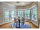 Cozy dining area with bay window and backyard view, next to glass patio doors to the outdoor deck at 910 Old Orchard Rd, Chapel Hill, NC 27517