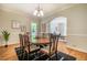 Lovely dining room with a round table, hardwood floors, and views to the living room at 910 Old Orchard Rd, Chapel Hill, NC 27517