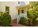 Inviting front porch and brick path lead to this two-story white home with lush landscaping at 910 Old Orchard Rd, Chapel Hill, NC 27517