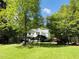 Charming two-story white home with a welcoming front porch and a beautifully landscaped yard at 910 Old Orchard Rd, Chapel Hill, NC 27517