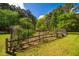 A fenced garden plot with a variety of plants and vegetables, perfect for gardening enthusiasts and sustainable living at 910 Old Orchard Rd, Chapel Hill, NC 27517