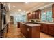 Large kitchen with cherry cabinets, island cooktop and eating bar, and hardwood flooring at 910 Old Orchard Rd, Chapel Hill, NC 27517