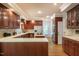 Bright kitchen featuring cherry wood cabinetry, island cooktop, and white countertops at 910 Old Orchard Rd, Chapel Hill, NC 27517