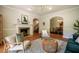 Comfortable living room with hardwood floors, fireplace, and an archway view into the dining room at 910 Old Orchard Rd, Chapel Hill, NC 27517