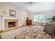Bright and airy main bedroom featuring a fireplace, hardwood floors, and natural light at 910 Old Orchard Rd, Chapel Hill, NC 27517