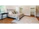 Comfortable main bedroom featuring a king size bed, hardwood floors, and natural light at 910 Old Orchard Rd, Chapel Hill, NC 27517