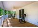 A spacious covered porch with rocking chairs, perfect for relaxing and enjoying the serene outdoor surroundings at 910 Old Orchard Rd, Chapel Hill, NC 27517